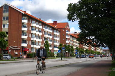 man biking down street