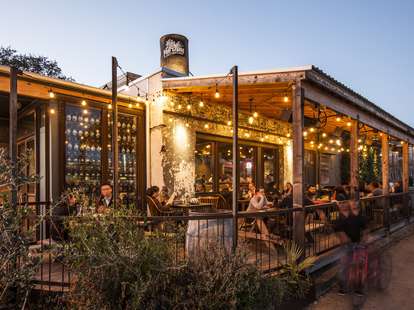 The Hay Merchant 12 Essential Restaurants HOU underbelly outdoor porch with string lights thrillist