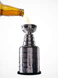 beer being poured into Stanley Cup