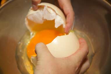 cracking open ostrich egg