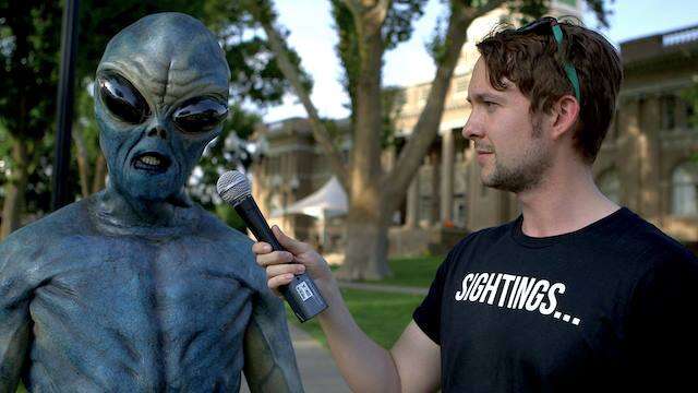 man interviewing alien