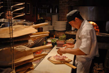 pizzaiolo in pizzeria kitchen