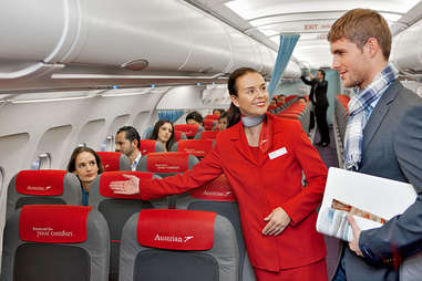 Flight attendant showing a seat
