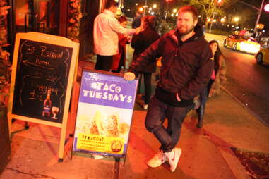 Cheapskate Tuesdays - Ben Robinson leaning on Hop Devil taco sign
