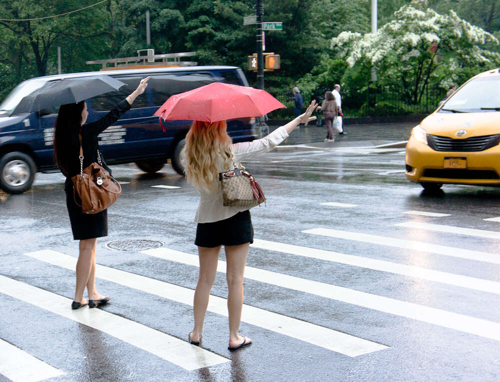 two women hailing a cab in new york city