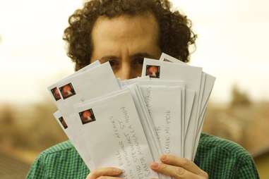 guy holding envelopes