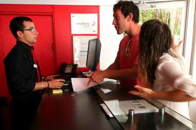 man being belligerent with hotel staff