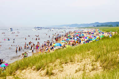 crowds of people and rainbow umbrellas on the shores of lake douglas