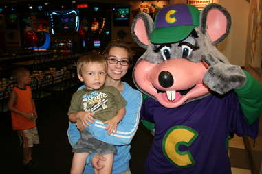 Chuck E. Cheese mascot with kid