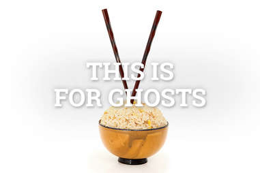 vertical chopsticks in rice