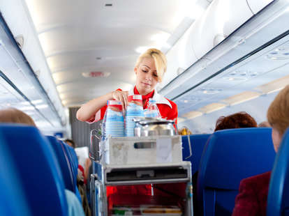 Flight Attendant Sitting In A Jump Seat With A Telephone High-Res Stock  Photo - Getty Images