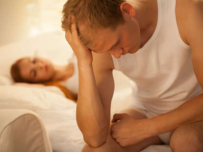 man experiencing whiskey dick in bed with woman