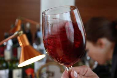 swirling a glass of red wine at barcelona wine bar and restaurant