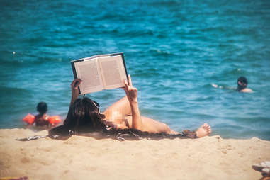 woman reading on beach