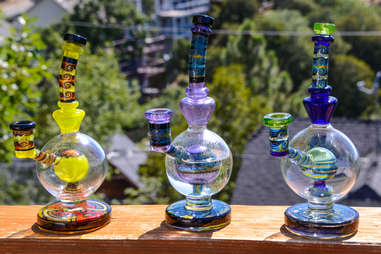 colorful dab rigs sitting on wooden balcony outside