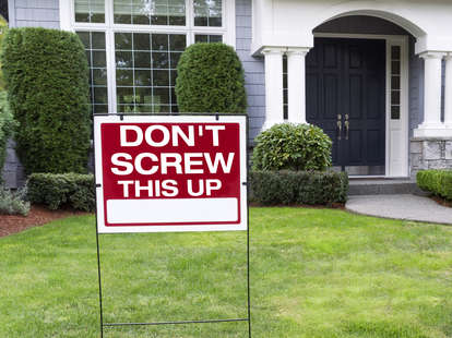 for sale sign in front of house