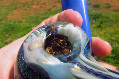 smoking weed from a bowl outside