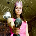 The Loved Ones actress stands threateningly with a power drill in a pink dress and crown