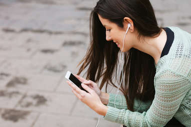 Woman listening to music on her smartphone