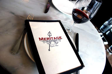 menu and glass of red wine at meritage