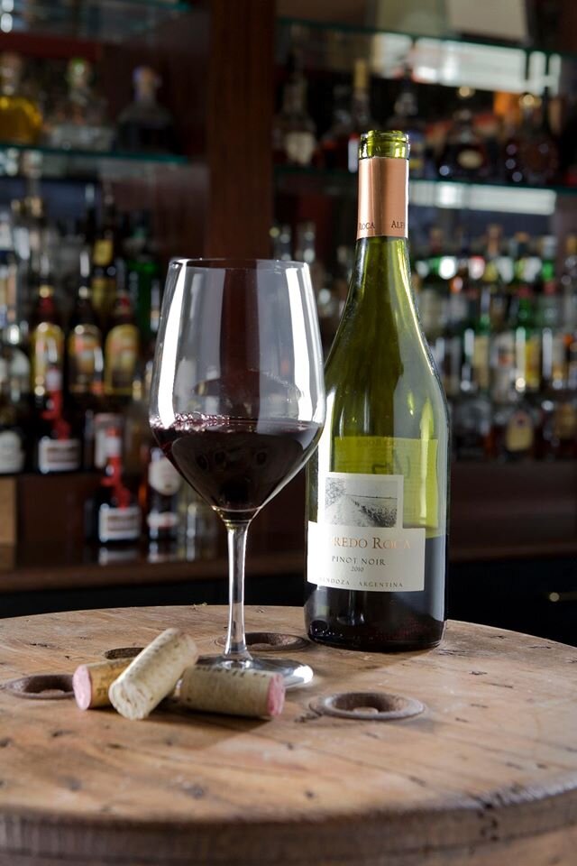 Glass of red wine and half-empty bottle at Cioppino restaurant