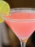Pink cosmolitan cocktail with lime wedge