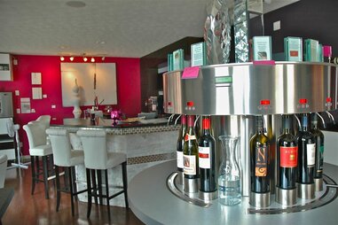 Wine carafe and row of wine bottles inside Shiraz wine cafe