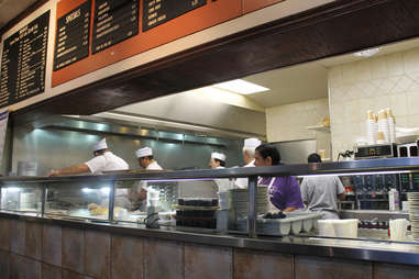 workers behind counter making breakfast at Valois in Chicago