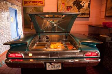hot nachos served out of a classic car at Chuy's