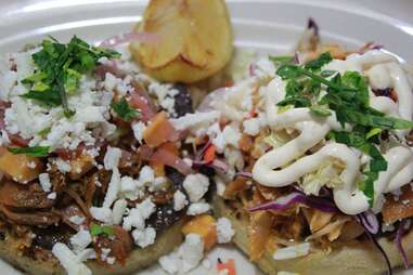 tacos with cojito cheese, beans, cilantro and lemon at Licha's Cantina