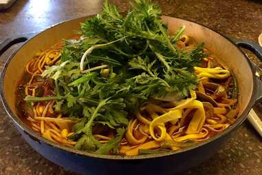 Spicy Korean beef broth soup with clams and wheat noodles