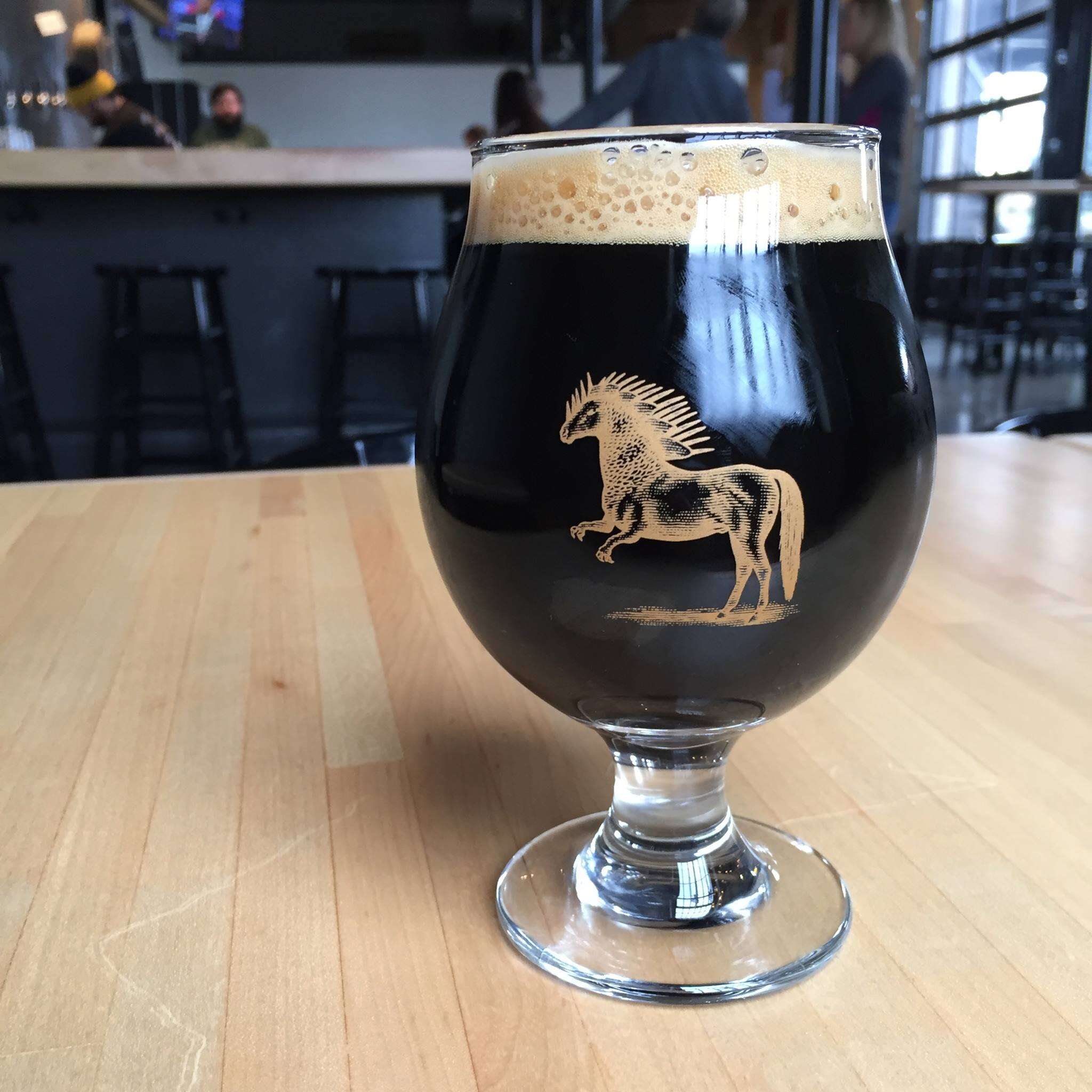 dark beer in a glass at Ponysaurus Brewing