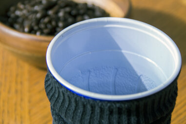 Roll the sock onto the funnel and fill