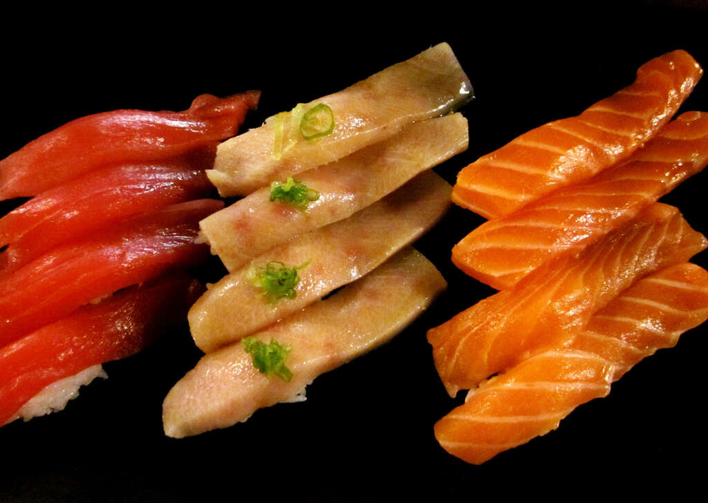 Salmon and tuna sushi laid in a row