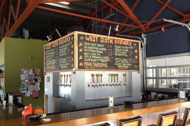 chalkboard menu at West Sixth Brewery with bar and taps