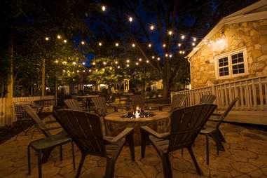patio with chairs and fire pit at Vin 25 wine bar