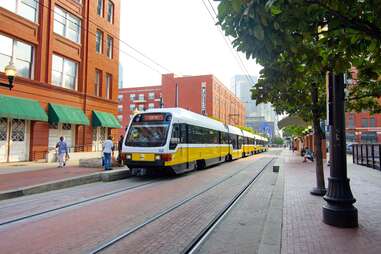 Dallas DART rail in the daytime stopping for passengers