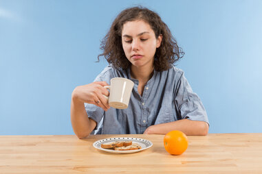 Tired woman looking for more coffee at breakfast
