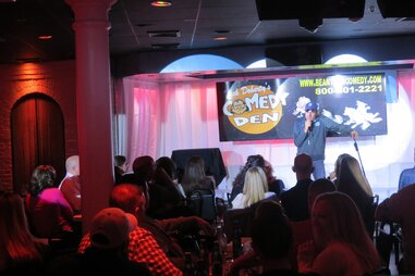 Comic performing to a full house at Dick Doherty’s Comedy Den