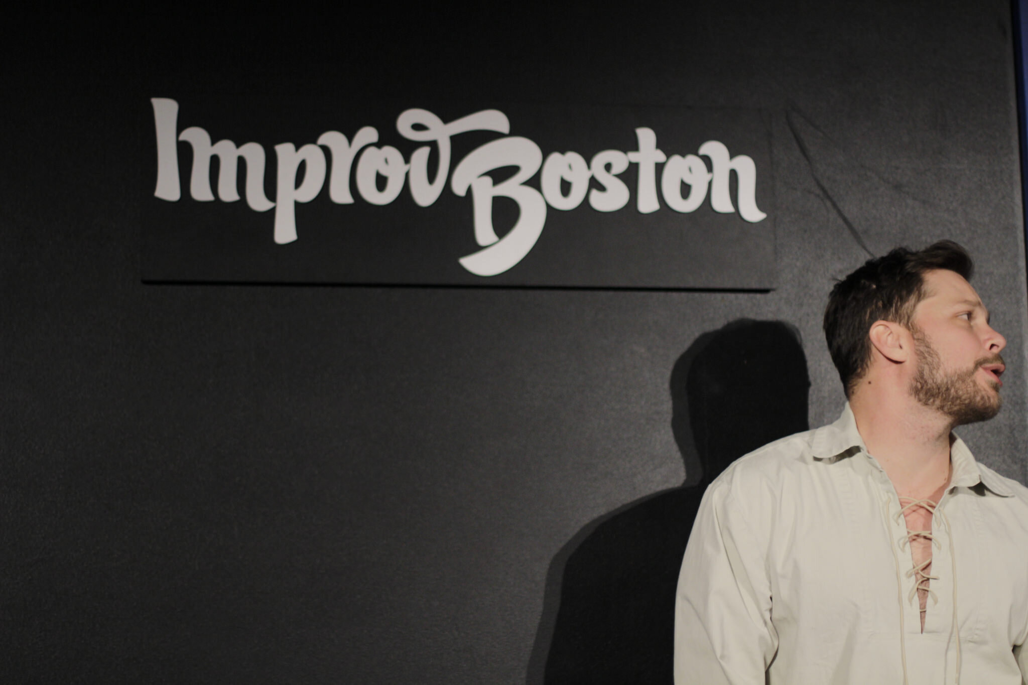 Comic speaking at ImprovBoston stage