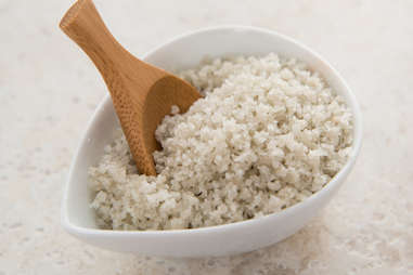 bowl of grey salt with a wooden spoon