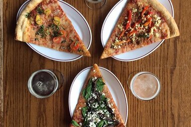 Different pizzas slices pointing arranged around each other