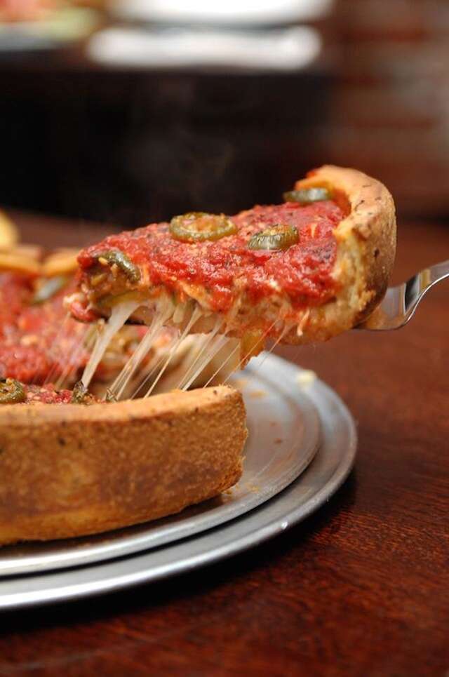 Slice of red deep dish pizza at Patxis