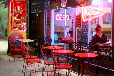 Exterior neon-lit facade of Oz Pizza