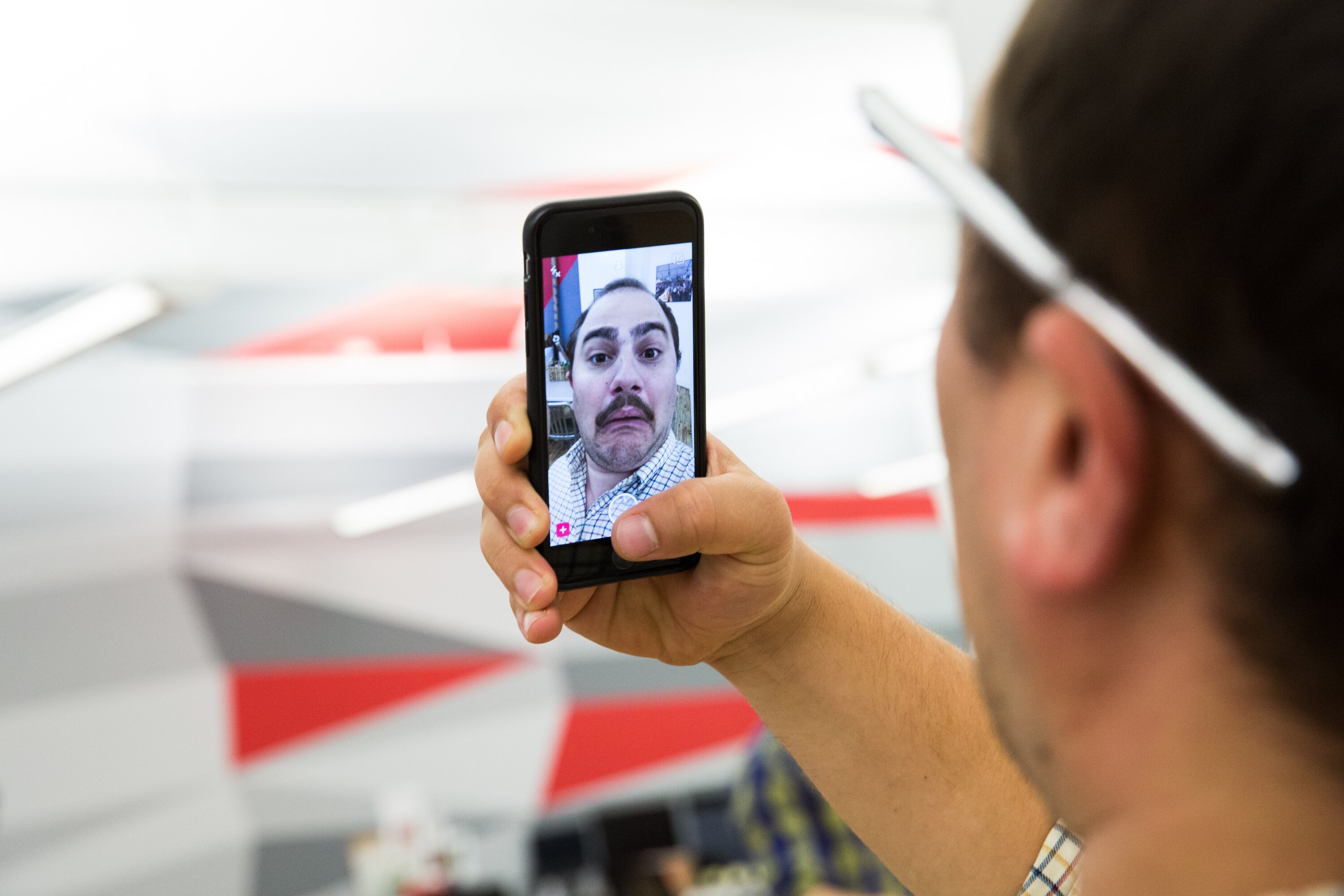 man using snapchat on an iPhone