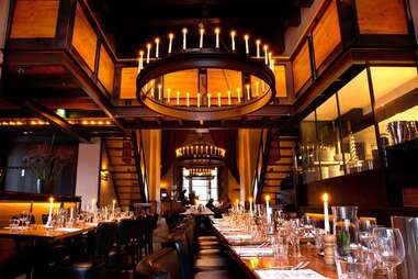 Chandelier and candles within classy In de Waag restaurant