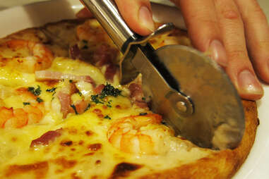 Personal pizza sliced by pizza cutter