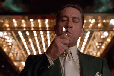 Robert DeNiro lighting a cigarette in Martin Scorsese’s Casino