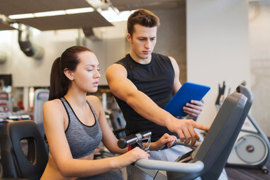 personal trainer with student on treadmill