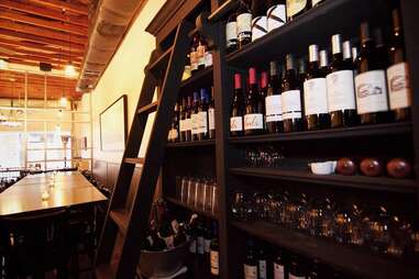 wines lined on a shelf at Vintage Enoteca